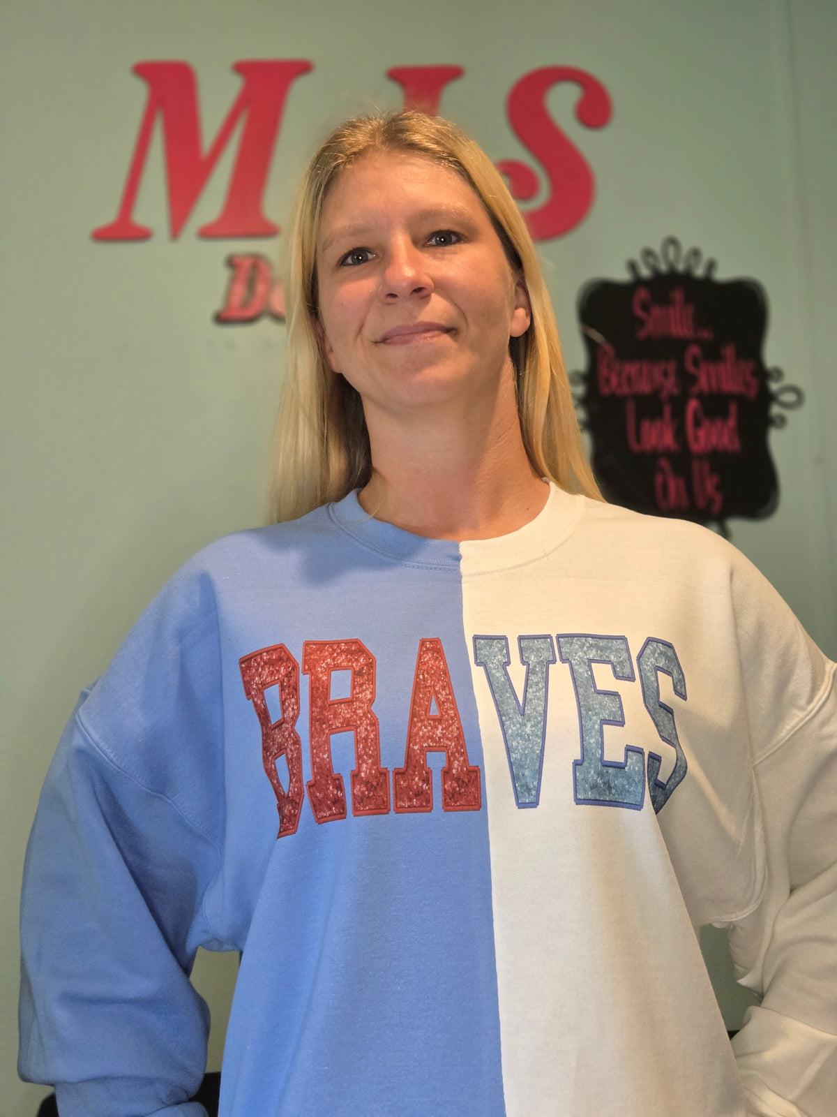 Sheena wearing a custom split-color Braves sweatshirt